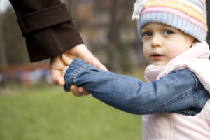 Consent orders family court concept - Child holding mother's hand